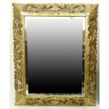 Large Carved Gilt Wood Decorative Mirror. Carved with deep relief. Small losses, splitting to