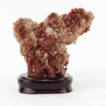 Vanadinite Mineral Specimen on Wooden Stand. Sphered structure with faceted crystals, pale and