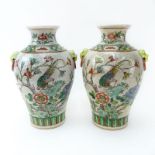 Pair of Modern Chinese Qing Dynasty Style Pottery Vases. Enamel painted flower and bird motif with