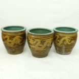 Three Large Chinese Pottery Jardinières. Each with continuous dragon motif on brown ground.