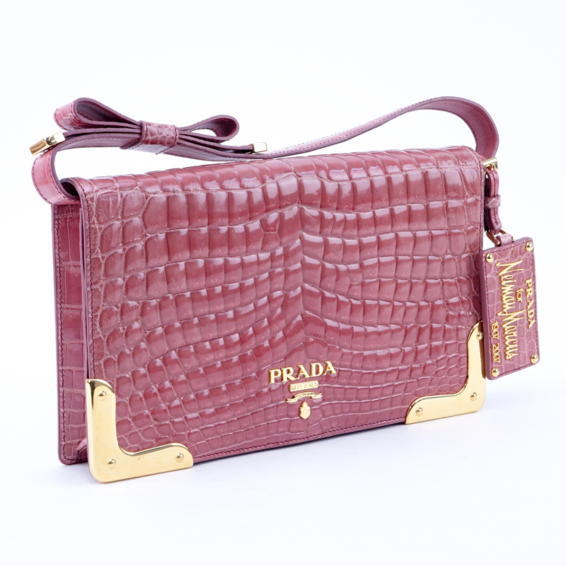 Prada Limited Edition Pink Crocodile Clutch. Gold tone hardware. Leather interior with zipper