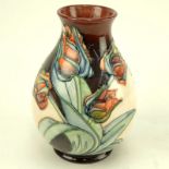 Moorcroft Pottery Vase. Tulip motif. Signed. Light crazing or in good condition. Measures 7-1/2"