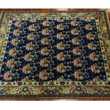 Semi-Antique Turkish Rug. Blue ground with busy floral motif. Good condition. Measures 9' x 12'.