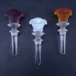 Three (3) Versace Rosenthal Crystal Medusa Wine Stoppers. Includes iridescent, amethyst, amber