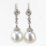 White Pearl, Approx. .91 Carat Round Brilliant Cut Diamond and 18 Karat White Gold Pendant Earrings.