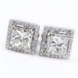 Approx. 3.56 Carat Diamond and 14 Karat White Gold Ear studs. Set with a 1.55 carat princess cut and