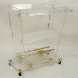 Large Mid Century Lucite And Brass Rolling Bar Cart. Three tiers. Unsigned. Remnants of glue at some