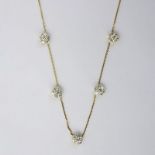 Van Cleef & Arpels 18 Karat And Diamond Fleurette. Features five diamond rosettes on delicate chain.