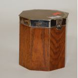An early 20th century oak and silver plated biscuit barrel of octagonal form with inner liner