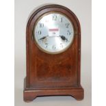 An Edwardian mahogany cased mantel clock having a silvered dial with Arabic numerals and eight day