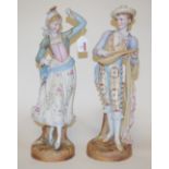 An early 20th century bisque porcelain figure of a man playing a lute together with a female