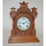 A late 19th century oak cased mantel clock by the Ansonia Clock Company of New York having an