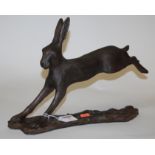 A modern resin figure of a hare on a naturalistic base,