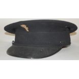 A reproduction British Union of Facists black peaked cap with cloth badge