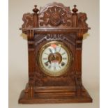 A late 19th century carved oak cased mantel clock by The Ansonia Clock Company of New York,