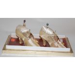 A pair of modern pin cushions in the form of a pair of ladies shoes