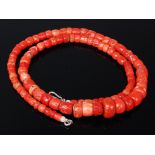 A beaded and graduated coral necklace, of mixed colour, many beads being pitted, 91g,