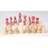 A Victorian carved ivory chess set, one side stained red, the other left natural,