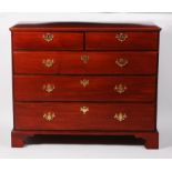 An early George III walnut squarefront chest, having two short and three long graduated drawers,
