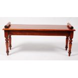 A Victorian style mahogany window seat, having turned ends and on ring turned tapering supports, w.