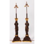 A large pair of French Empire style bronze and gilt bronze table lamps and shades;