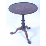 A George III mahogany pedestal tripod table, having a circular tilt-top on a birdcage action,