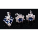 A pair of white metal, sapphire and diamond set ear studs, each arranged as a flower head cluster,