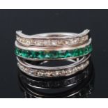 A contemporary 14ct white gold, ruby, emerald and diamond set triple eternity ring,