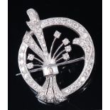 A white metal and diamond set openwork brooch, arranged as a posy of flowers within an oval border,