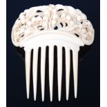 A late 19th century ivory comb, carved with scroll leaves and branches issuing bellflowers, w.