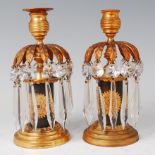 A pair of mid-19th century bronze and gilt bronze lustre table candlesticks,