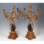 A pair of circa 1900 French bronze and gilt metal seven light candelabrum,