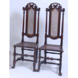 A pair of late 17th century Dutch walnut highback side chairs, each with swept top rails,