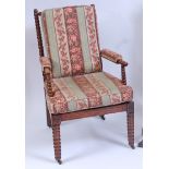 A Victorian walnut bobbin turned open armchair, having floral striped cushion upholstery,