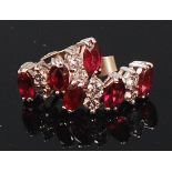 A pair of white metal, ruby and diamond set ear studs,