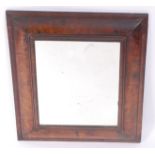 An antique walnut veneered cushion framed wall mirror, early 18th century with alterations,