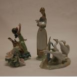 A collection of four various Lladro figures to include; girl with lamb, dancer, geese,
