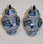 A pair of Royal Bonn Delft blue & white jars and covers,
