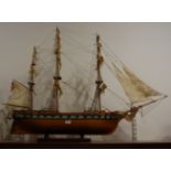 A large scratch-built wooden model of a three-masted frigate