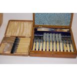 An Edwardian oak cased twelve place setting of silver plated fish cutlery;