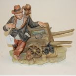 A Capo di Monte figure of an organ-grinder (a/f)