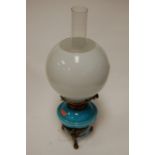 A Victorian oil lamp having opalescent globular glass shade,
