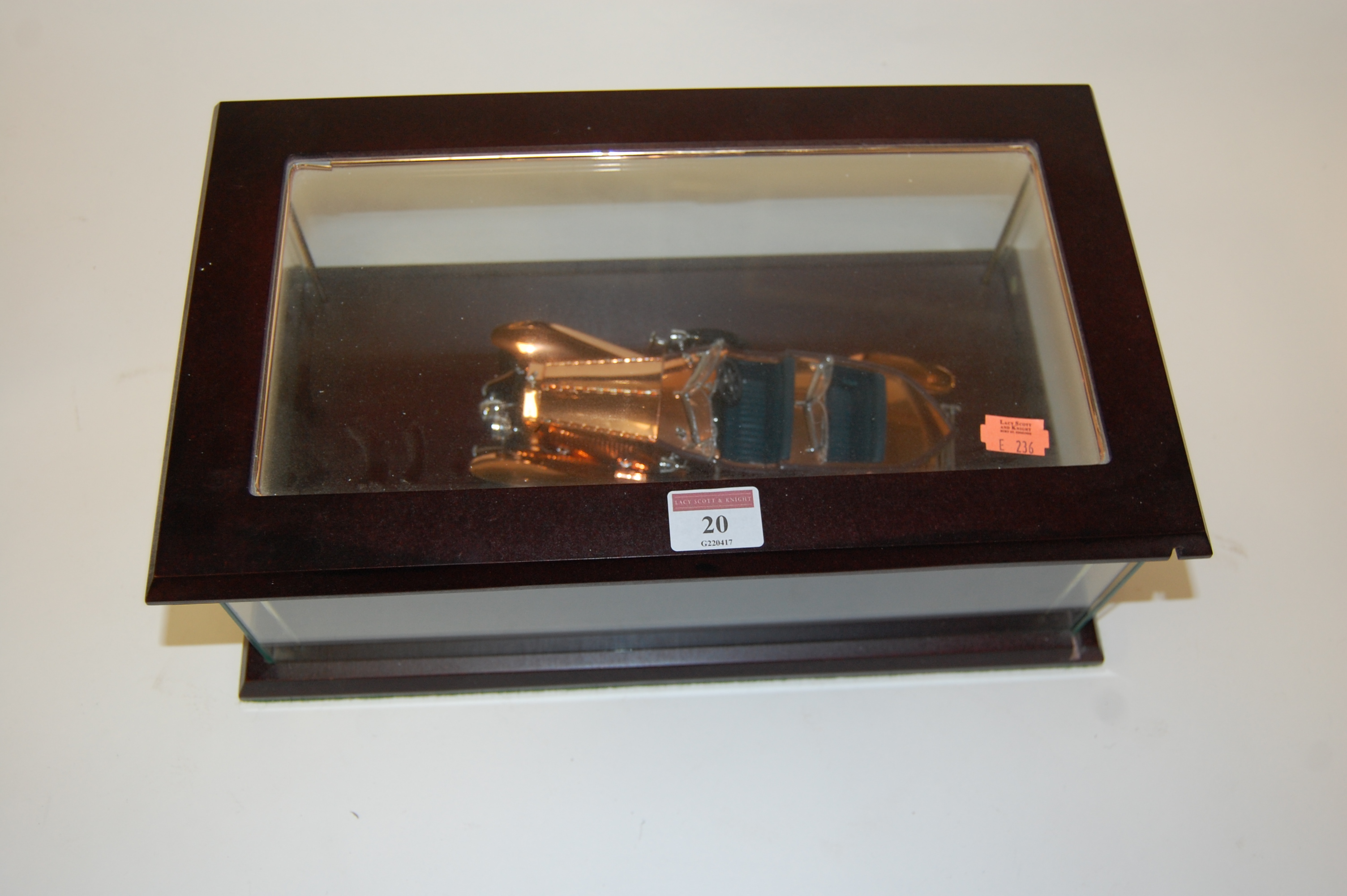 A diecast scale model of a Rolls Royce in glazed display case