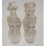 A set of three 19th century fluted glass decanters each with mushroom shaped stopper together with