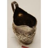 A George III silver helmet shaped cream jug,