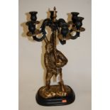 A large lacquered brass figure of a rabbit supporting a six sconce candelabra, on plinth base, h.