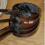 A set of four 19th century copper pans,
