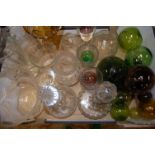 A box of mixed coloured and clear glass ware to include decorative glass balls, decanters,