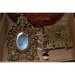A box of miscellaneous items to include; embossed copper tray, pierced brass trivet,