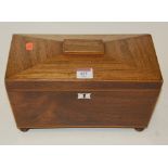 A Regency faded rosewood tea caddy of sarcophagus form having fitted interior flanked by lion mask